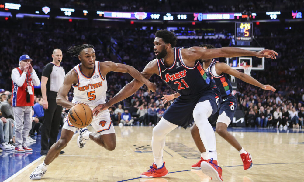 Feb 27, 2022; New York, New York, USA; New York Knicks guard Immanuel Quickley (5) looks to drive past Philadelphia 76ers center Joel Embiid (21) in the fourth quarter at Madison Square Garden. Mandatory Credit: Wendell Cruz-USA TODAY Sports