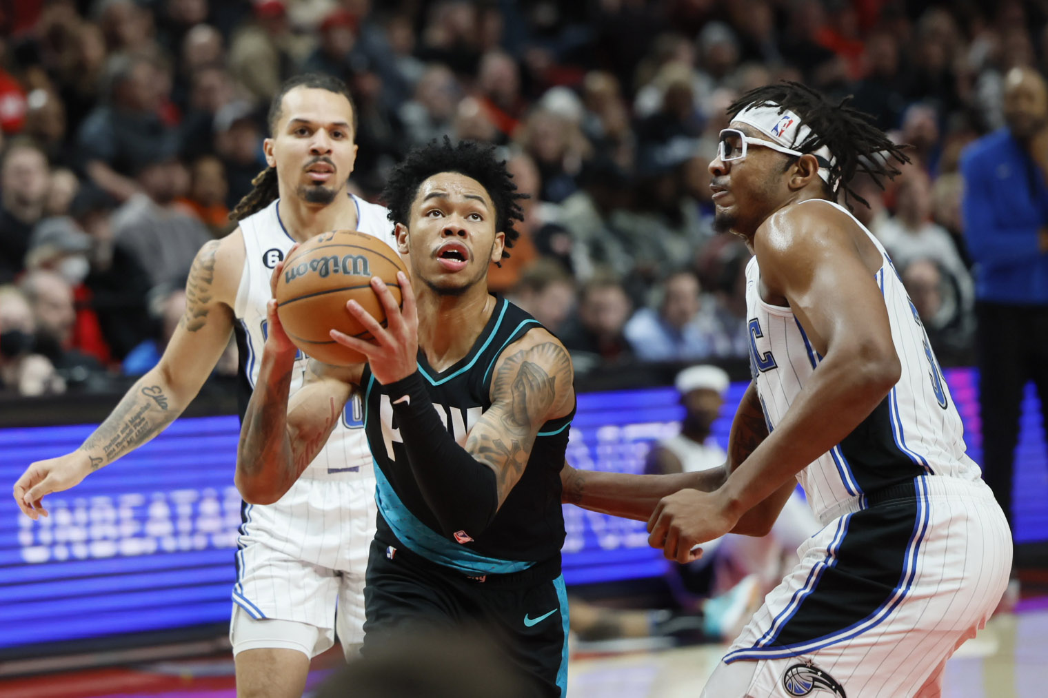 Jan 10, 2023; Portland, Oregon, USA; Portland Trail Blazers shooting guard Anfernee Simons (1) drives to the basket against Orlando Magic center Wendell Carter Jr. (34, right) during the first half at Moda Center. Mandatory Credit: Soobum Im-USA TODAY Sports