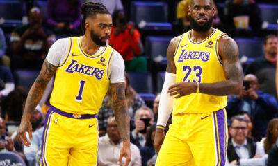 Mar 27, 2024; Memphis, Tennessee, USA; Los Angeles Lakers guard D'Angelo Russell (1) and forward LeBron James (23) wait for play to start against the Memphis Grizzlies at FedExForum. Mandatory Credit: Petre Thomas-USA TODAY Sports