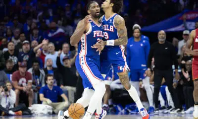 Apr 17, 2024; Philadelphia, Pennsylvania, USA; Philadelphia 76ers center Joel Embiid (21) and guard Kelly Oubre Jr. (9) collide while going for a loose ball during the fourth quarter against the Miami Heat of a play-in game of the 2024 NBA playoffs at Wells Fargo Center. Mandatory Credit: Bill Streicher-USA TODAY Sports