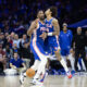 Apr 17, 2024; Philadelphia, Pennsylvania, USA; Philadelphia 76ers center Joel Embiid (21) and guard Kelly Oubre Jr. (9) collide while going for a loose ball during the fourth quarter against the Miami Heat of a play-in game of the 2024 NBA playoffs at Wells Fargo Center. Mandatory Credit: Bill Streicher-USA TODAY Sports