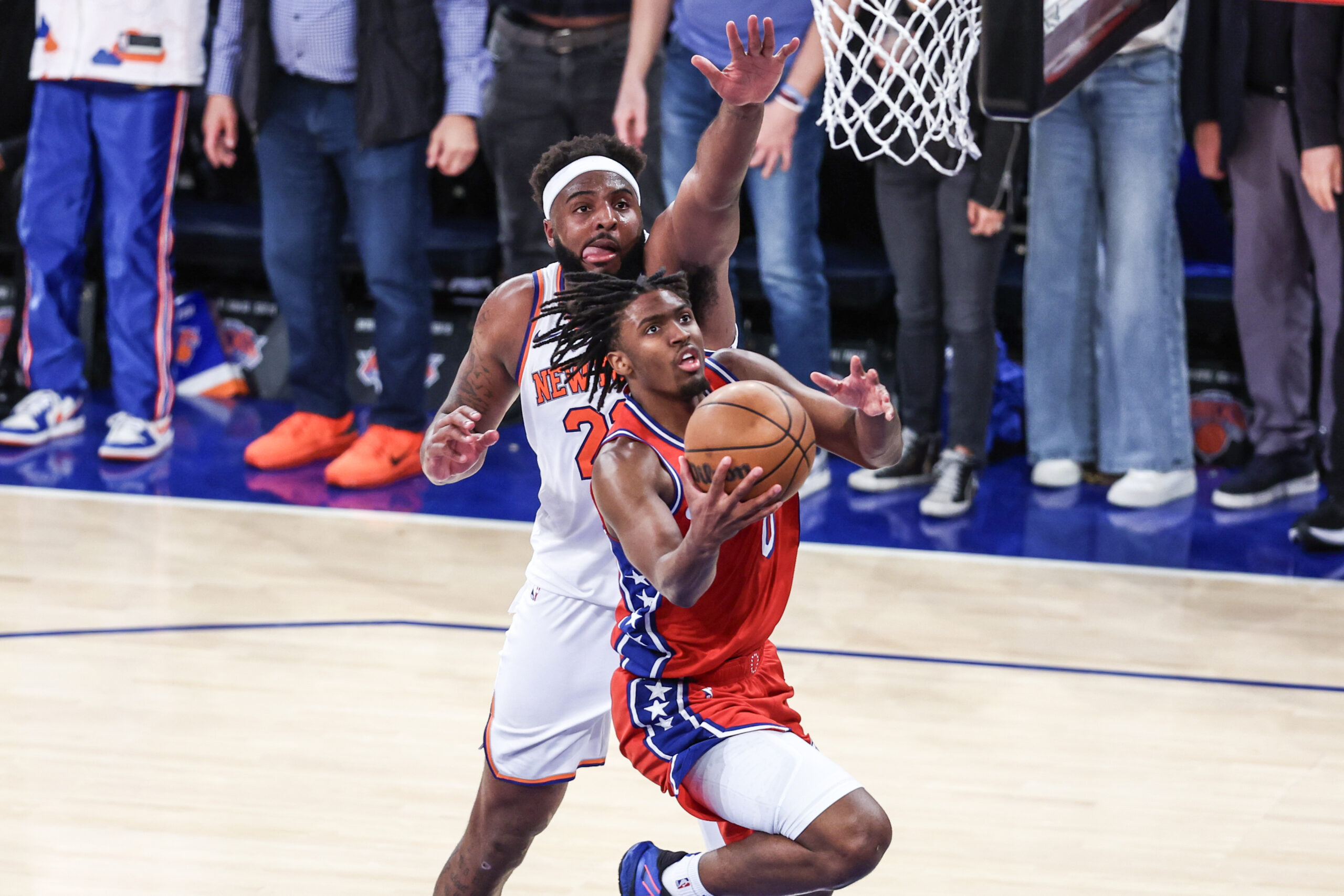 Apr 20, 2024; New York, New York, USA; Philadelphia 76ers guard Tyrese Maxey (0) drives past New York Knicks center Mitchell Robinson (23) in the fourth quarter in game one of the first round for the 2024 NBA playoffs at Madison Square Garden. Mandatory Credit: Wendell Cruz-USA TODAY Sports
