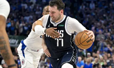 Apr 26, 2024; Dallas, Texas, USA; Dallas Mavericks guard Luka Doncic (77) is fouled by LA Clippers guard Russell Westbrook (0) during the fourth quarter during game three of the first round for the 2024 NBA playoffs at the American Airlines Center. Mandatory Credit: Jerome Miron-USA TODAY Sports