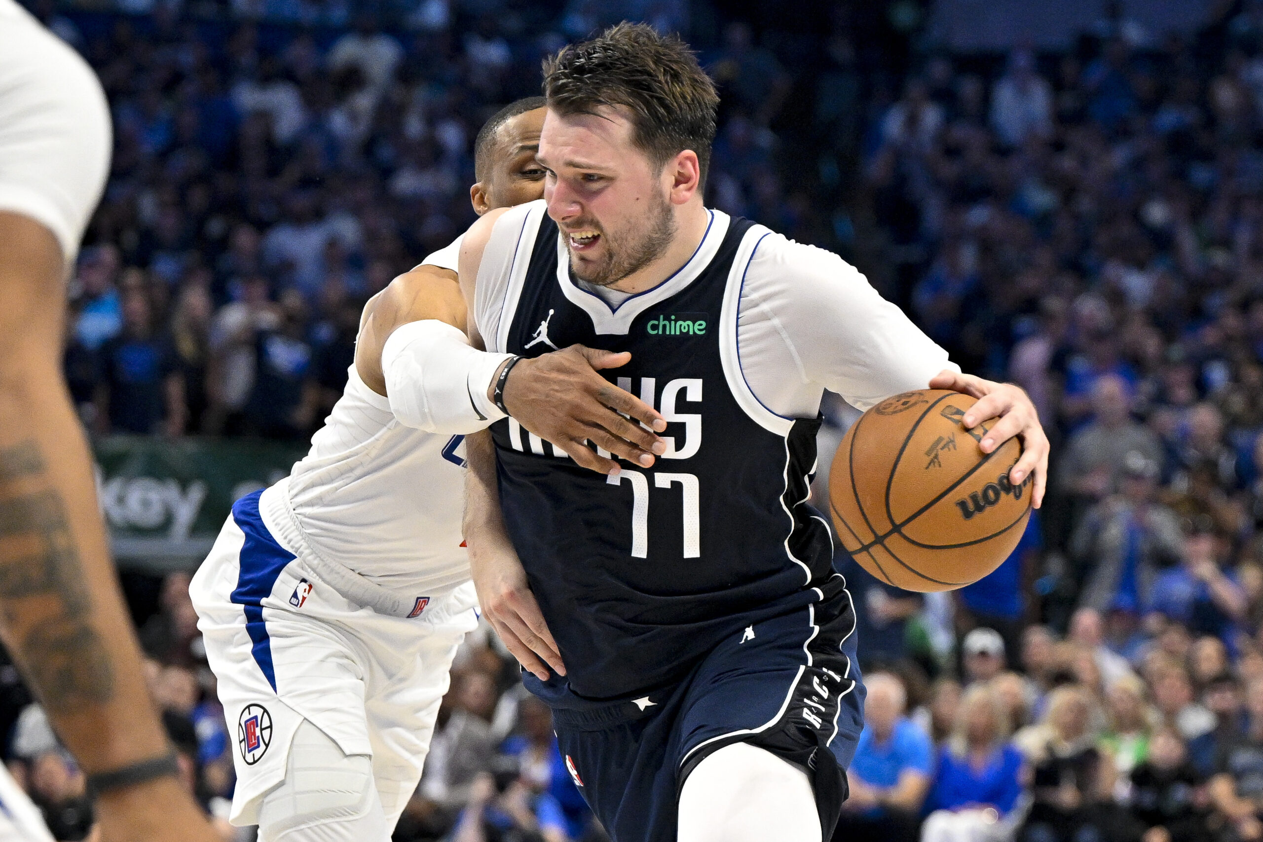 Apr 26, 2024; Dallas, Texas, USA; Dallas Mavericks guard Luka Doncic (77) is fouled by LA Clippers guard Russell Westbrook (0) during the fourth quarter during game three of the first round for the 2024 NBA playoffs at the American Airlines Center. Mandatory Credit: Jerome Miron-USA TODAY Sports