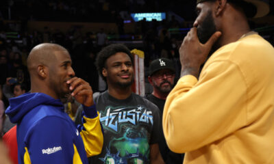 Oct 13, 2023; Los Angeles, California, USA; Golden State Warriors guard Chris Paul (3, left) talks with Los Angeles Lakers forward LeBron James (23, right) as LeBron's son Bronny (center) looks on after an NBA preseason basketball game at Crypto.com Arena. Mandatory Credit: Kiyoshi Mio-USA TODAY Sports