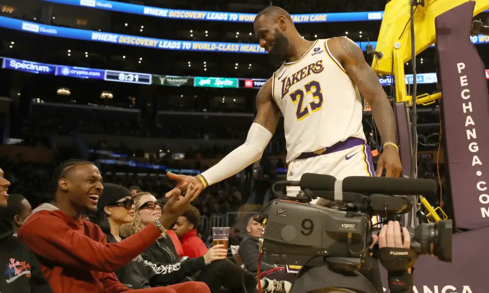 Nov 19, 2023; Los Angeles, California, USA; Los Angeles Lakers forward LeBron James (23) shakes hands with his son Bronny James during the second half against the Houston Rockets at Crypto.com Arena. Mandatory Credit: Kiyoshi Mio-USA TODAY Sports