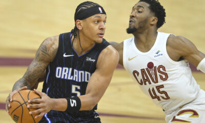 Apr 22, 2024; Cleveland, Ohio, USA; Orlando Magic forward Paolo Banchero (5) looks to pass beside Cleveland Cavaliers guard Donovan Mitchell (45) in the first quarter during game two of the first round of the 2024 NBA playoffs at Rocket Mortgage FieldHouse. Mandatory Credit: David Richard-USA TODAY Sports