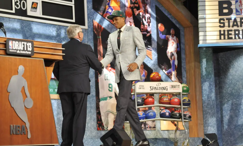Jun 27, 2013; Brooklyn, NY, USA; Giannis Antetokounmpo shakes hands with NBA commissoiner David Stern after being selected as the number fifteen overall pick to the Milwaukee Bucks during the 2013 NBA Draft at the Barclays Center. Mandatory Credit: Joe Camporeale-USA TODAY Sports