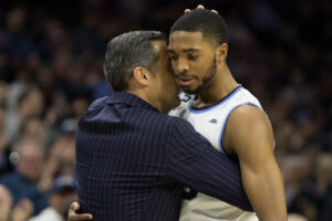 Mar 3, 2018; Philadelphia, PA, USA; Villanova Wildcats guard Mikal Bridges (25) and head coach Jay Wright hug as he leaves the game during the second half against the Georgetown Hoyas at Wells Fargo Center. Mandatory Credit: Bill Streicher-USA TODAY Sports