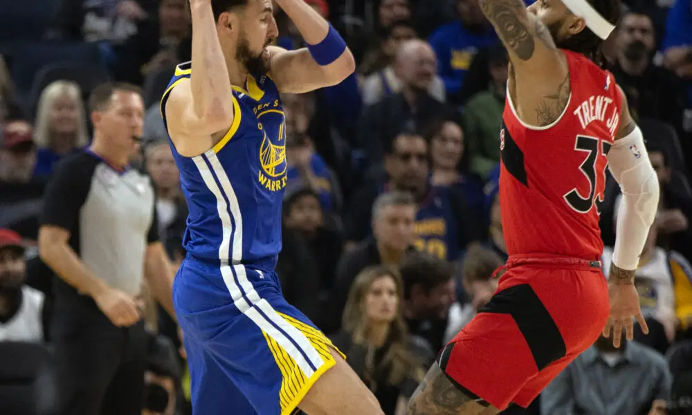 Jan 27, 2023; San Francisco, California, USA; Golden State Warriors guard Klay Thompson (11) looks to pass around Toronto Raptors guard Gary Trent Jr. (33) during the first quarter at Chase Center. Mandatory Credit: D. Ross Cameron-USA TODAY Sports