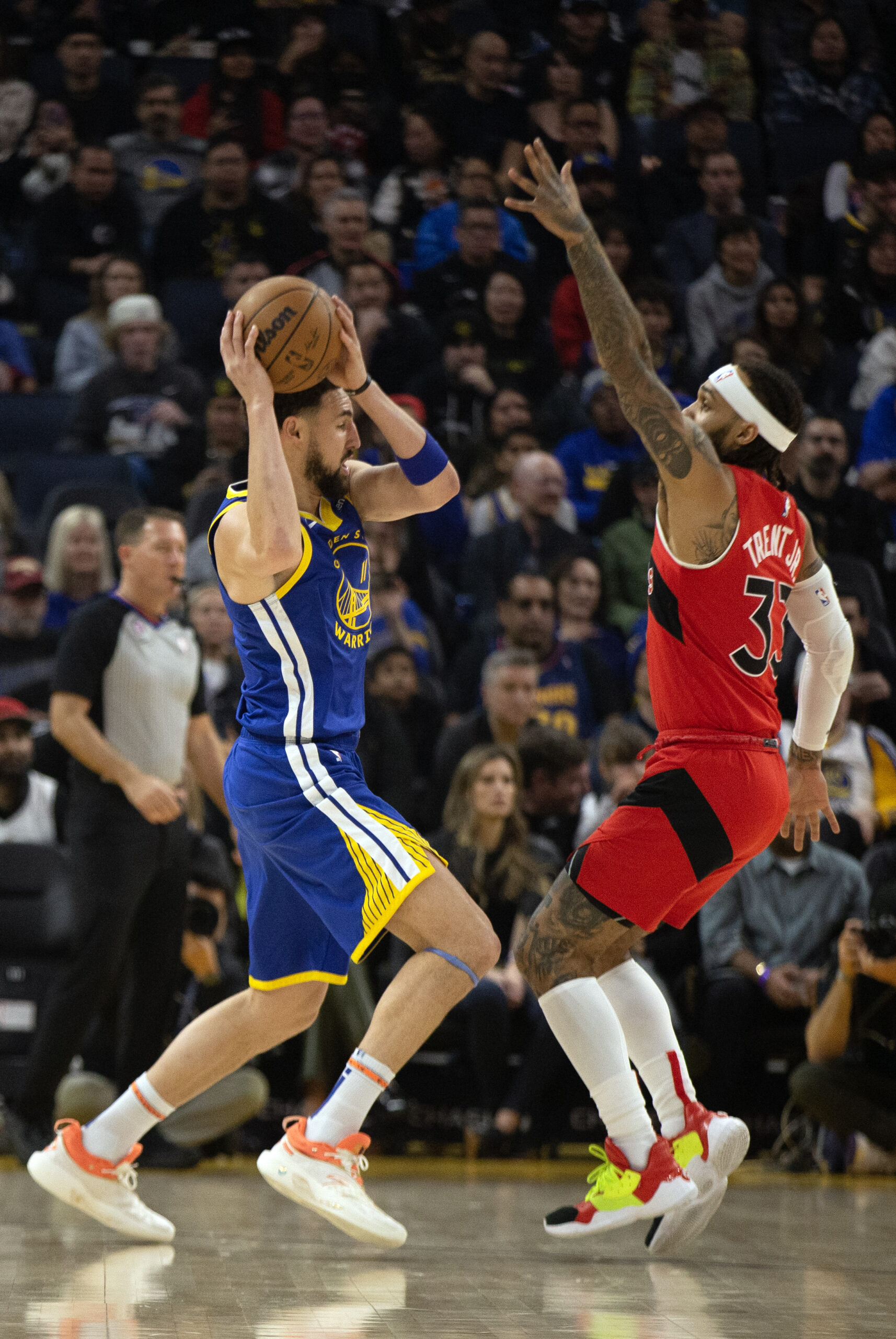 Jan 27, 2023; San Francisco, California, USA; Golden State Warriors guard Klay Thompson (11) looks to pass around Toronto Raptors guard Gary Trent Jr. (33) during the first quarter at Chase Center. Mandatory Credit: D. Ross Cameron-USA TODAY Sports