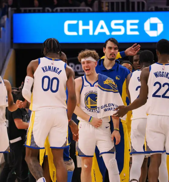 Dec 6, 2023; San Francisco, California, USA; Golden State Warriors guard Brandin Podziemski (2) celebrates with forward Jonathan Kuminga (00) after a time out is called against the Portland Trail Blazers during the fourth quarter at Chase Center. Mandatory Credit: Kelley L Cox-USA TODAY Sports