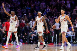 Jan 22, 2024; Phoenix, Arizona, USA; Phoenix Suns forward Kevin Durant (35) and Phoenix Suns guard Bradley Beal (3) and Phoenix Suns guard Devin Booker (1) reacts during the second half of the game against the Chicago Bulls at Footprint Center. Mandatory Credit: Joe Camporeale-USA TODAY Sports