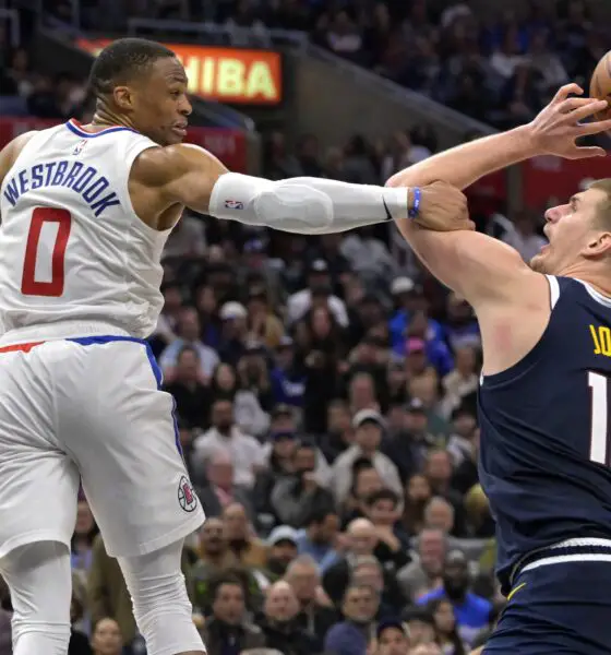 Apr 4, 2024; Los Angeles, California, USA; Denver Nuggets center Nikola Jokic (15) is fouled by Los Angeles Clippers guard Russell Westbrook (0) in the second half at Crypto.com Arena. Mandatory Credit: Jayne Kamin-Oncea-USA TODAY Sports