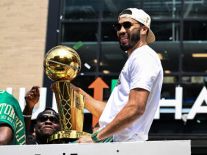 Jun 21, 2024; Boston, MA, USA; Boston Celtics forward Jayson Tatum (0) holds the Larry O'Brien Championship Trophy during the 2024 NBA Championship parade in Boston. Mandatory Credit: Brian Fluharty-USA TODAY Sports