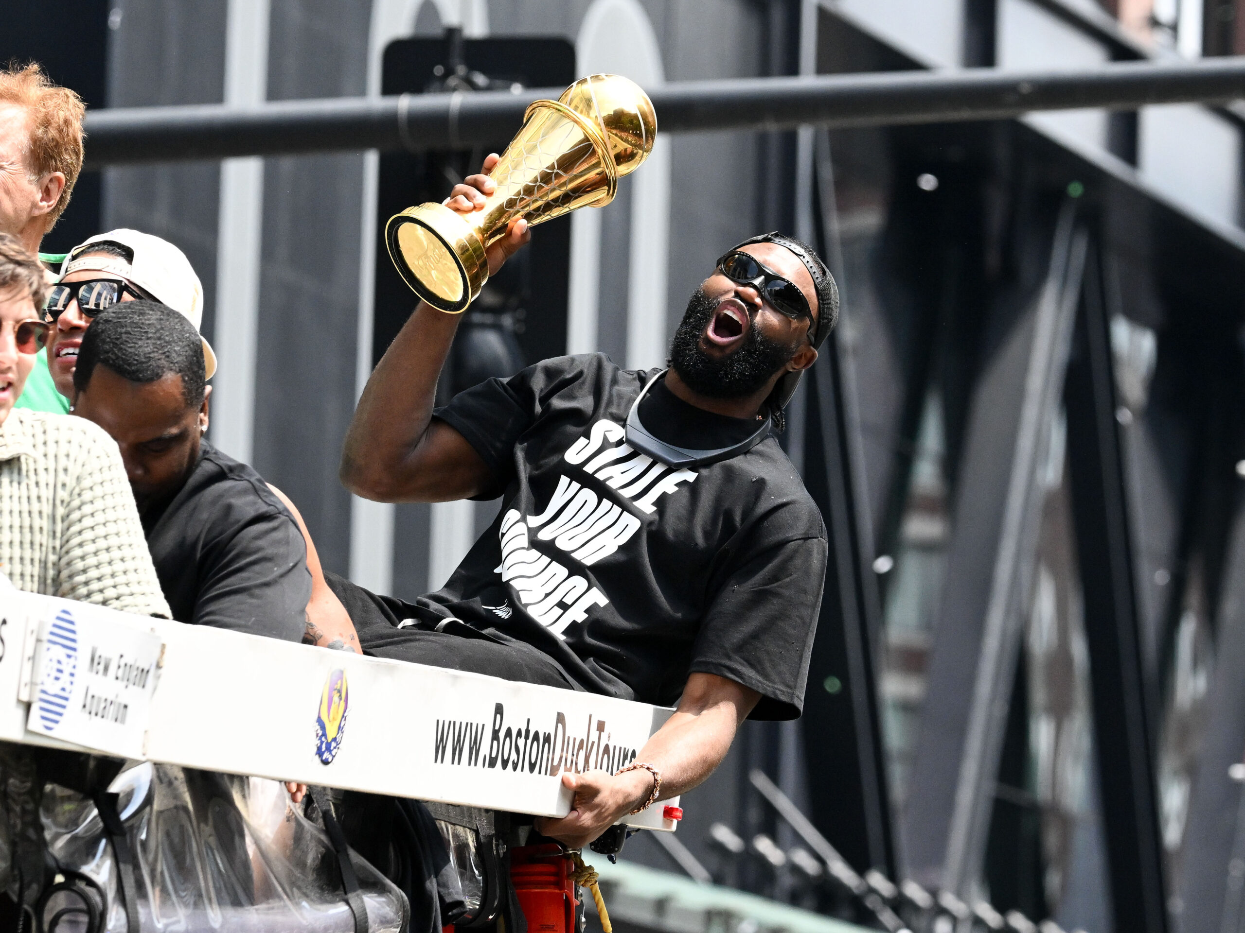 Jun 21, 2024; Boston, MA, USA; Boston Celtics guard Jaylen Brown (7) holds the MVP trophy during the 2024 NBA Championship parade in Boston. Mandatory Credit: Brian Fluharty-USA TODAY Sports