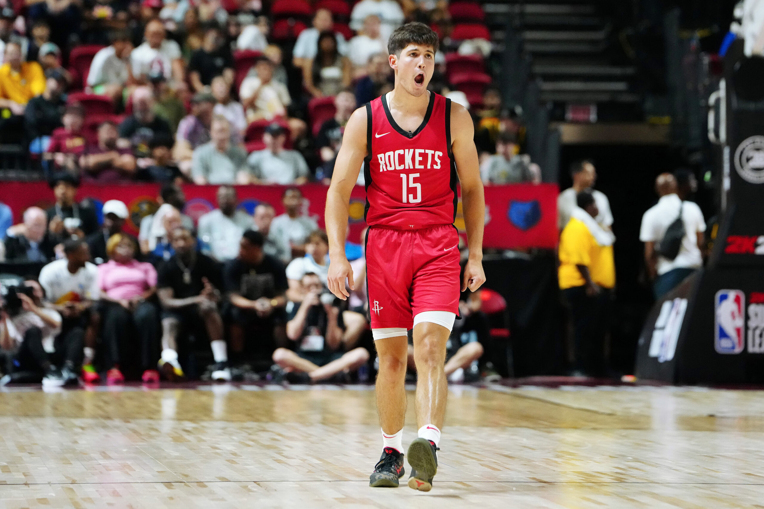 Jul 14, 2024; Las Vegas, NV, USA; Houston Rockets guard Reed Sheppard (15) reacts after scoring against the Washington Wizards during the third quarter at Thomas & Mack Center. Mandatory Credit: Stephen R. Sylvanie-USA TODAY Sports